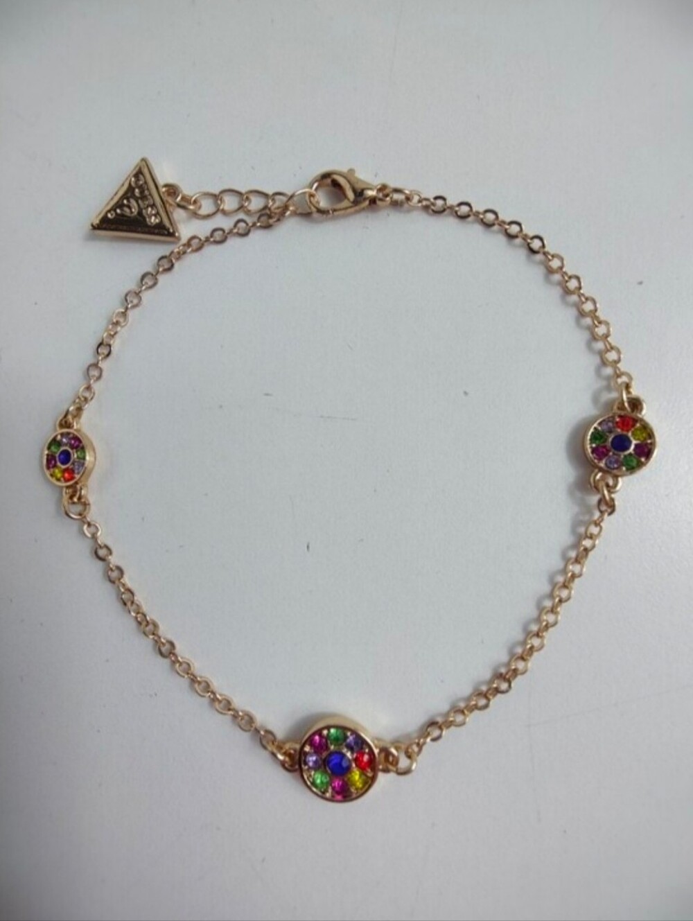 GUESS Gold Tone Multicolor Crystal Station Bracelet Signed Logo Charm Adjustable